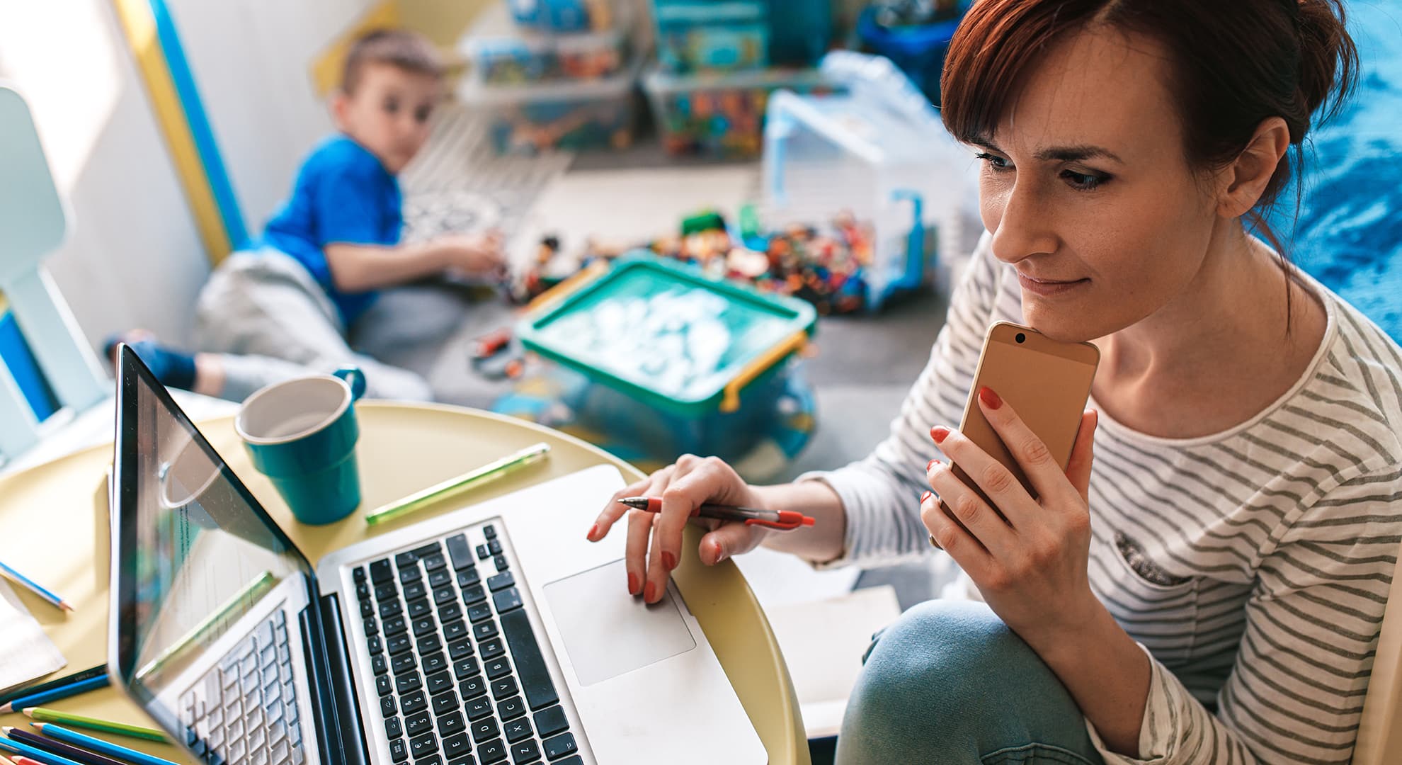 Busy mother studying at home with child