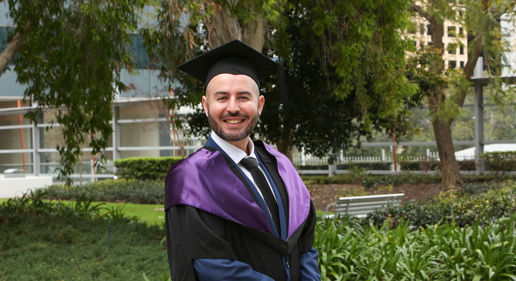 Alvaro Valdes Salazar is dressed in full regalia and cap at his graduation ceremony