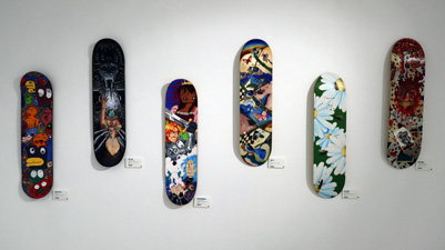 Skateboards with designs on them in the Young Originals art exhibition.