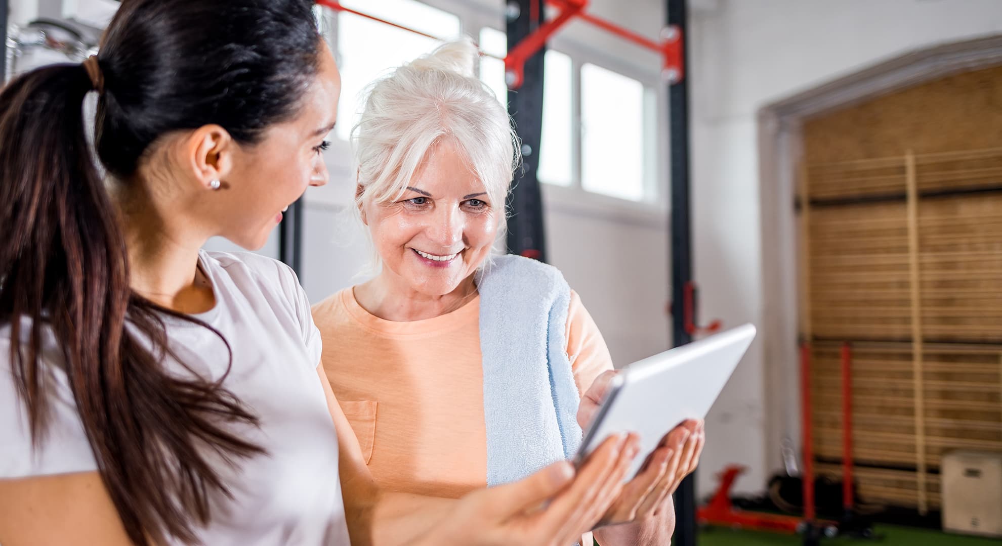 Woman with her personal trainer at gym.