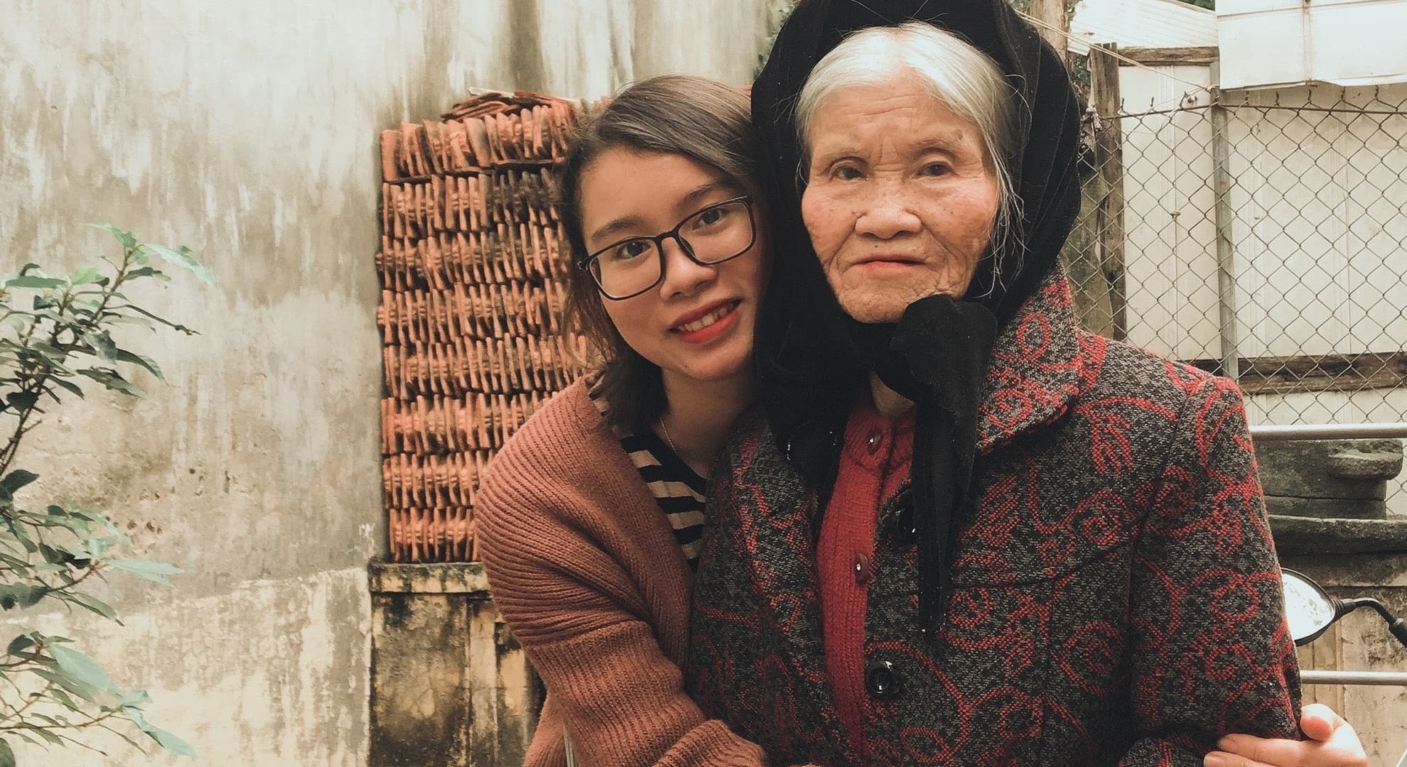 Older woman being comforted by younger girl.