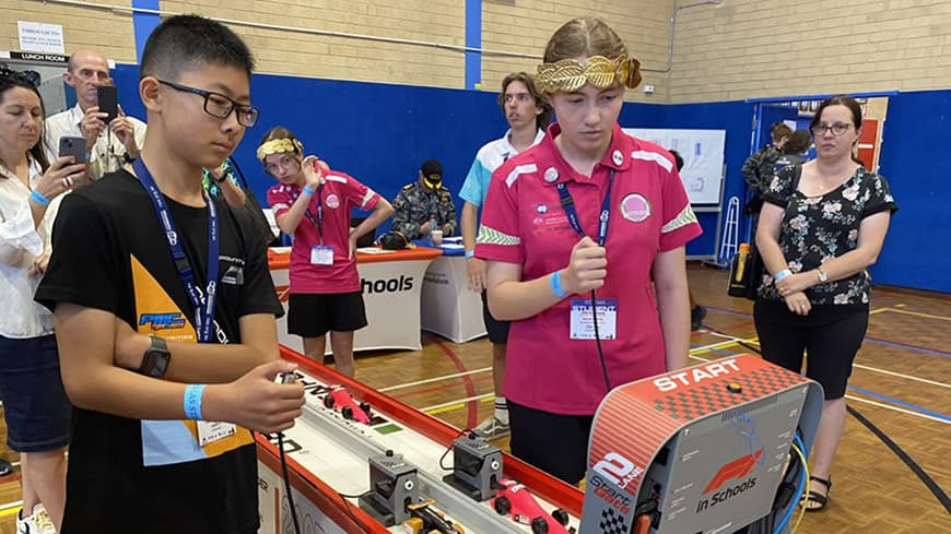 Team member Eden at the F1 in Schools racetrack starting line.