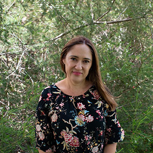 A portrait photo of Ms Tammy Green standing in front of a tree