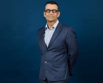  Associate Professor Laurie Hughes in front of a navy blue background