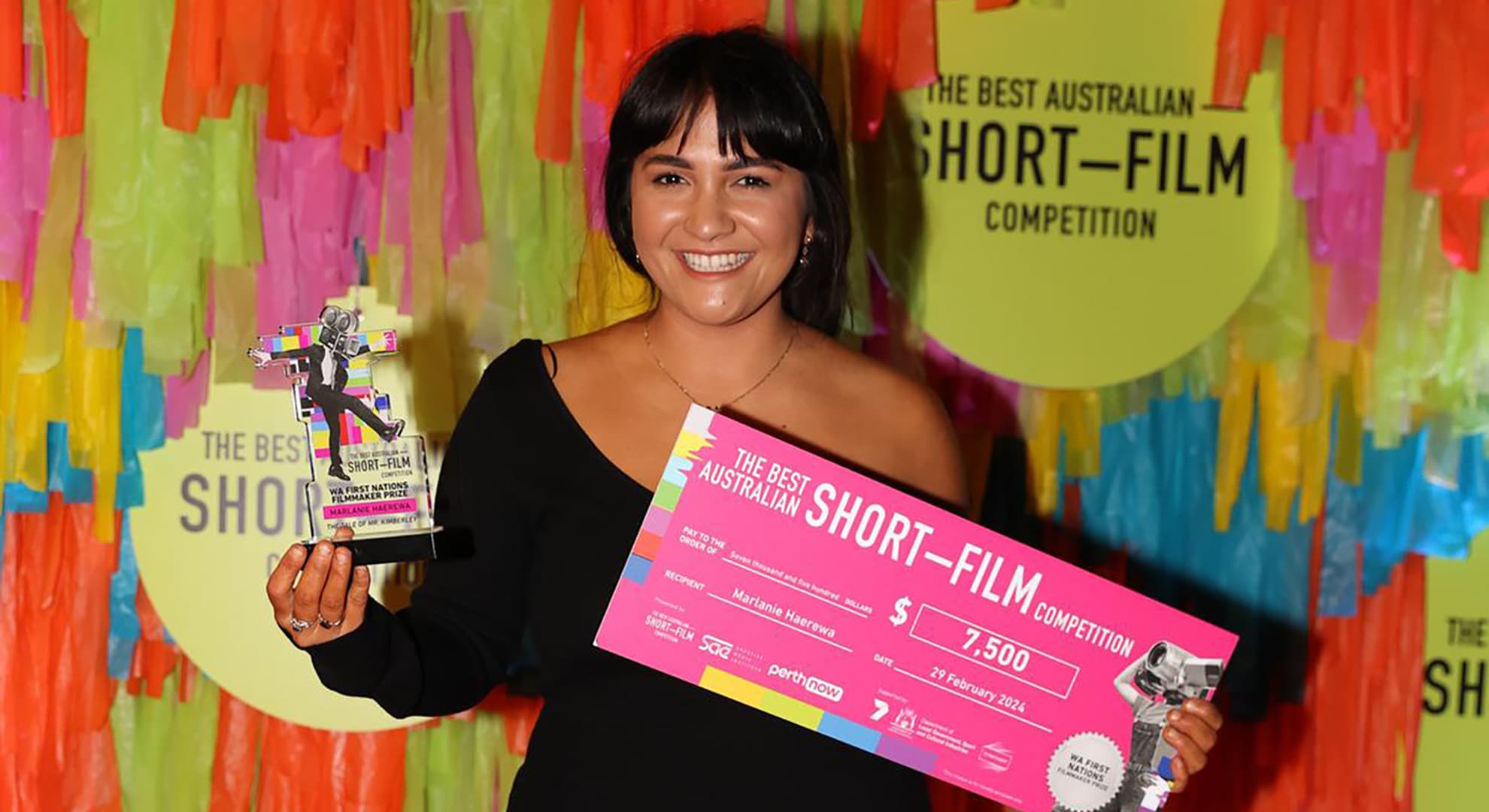 Marlanie Haerewa holds a trophy and a pink cheque for winning the First Nations Filmmaker Prize.