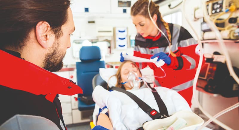 Paramedics treating patient in ambulance