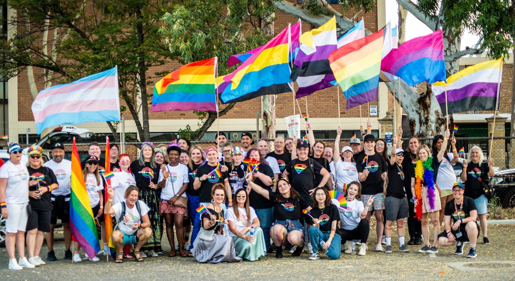 Group of people stand to celebrate Trans Day of Visibility