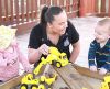 Early Learning Educator with toddlers playing.