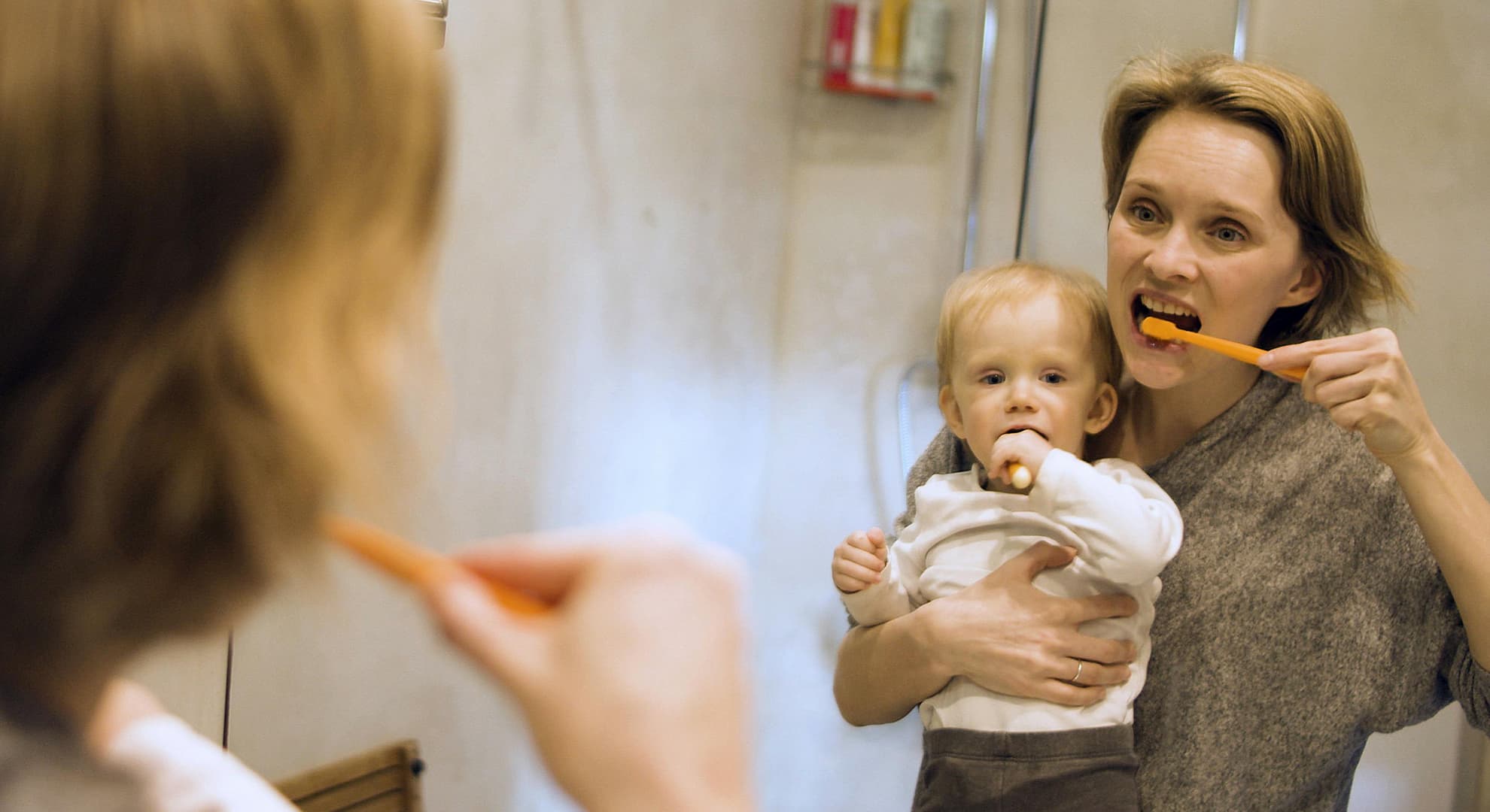 Mom and baby brushing teeth