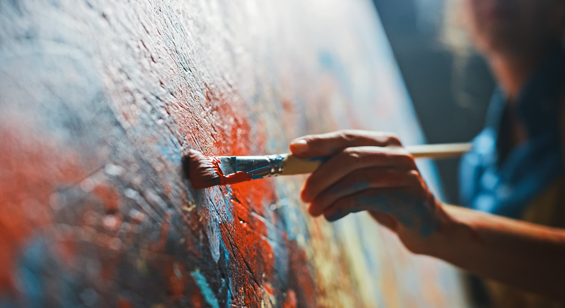Person painting on canvas