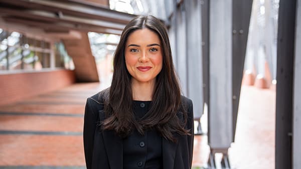 A woman facing the camera outside ECU Joondalup buildings