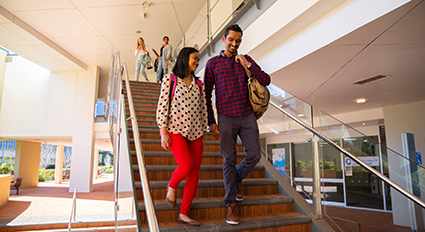 two students walking down a set of starirs