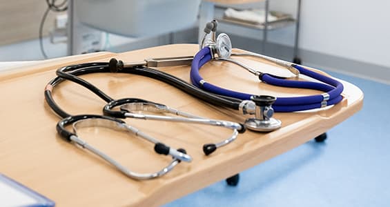 Stethoscopes on clinical table