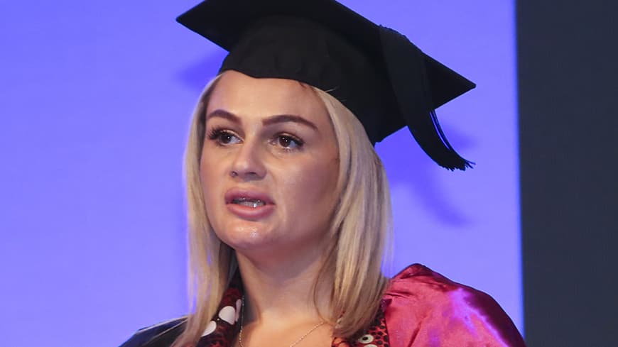 Young woman making a speech at a graduation ceremony