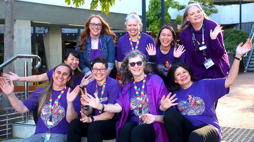 A lively group of ECU staff members dressed in purple for Wear It Purple Day.