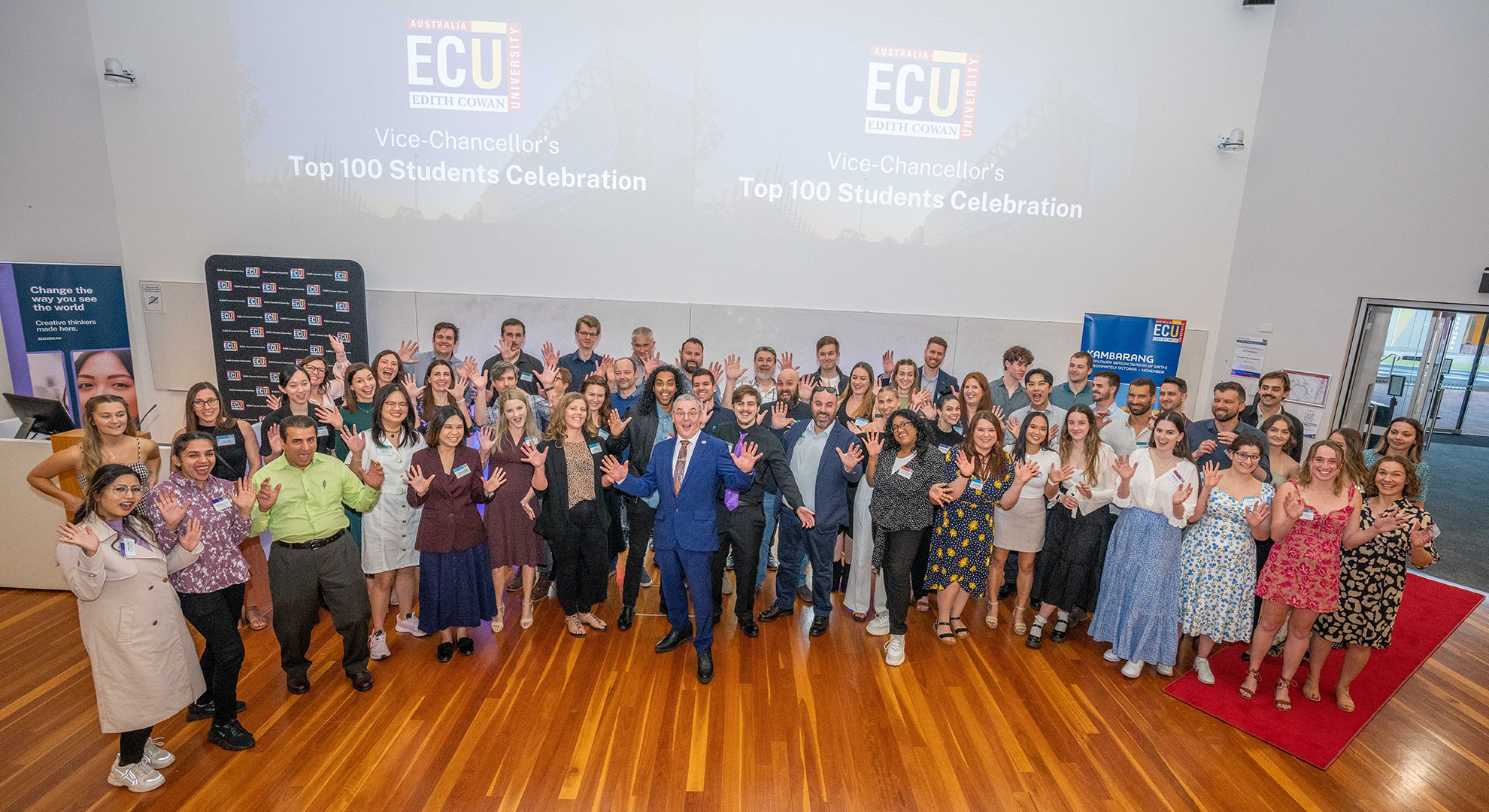 ECU Vice-Chancellor Professor Steve Chapman with the Top 100 Students put up jazz hands in celebration.