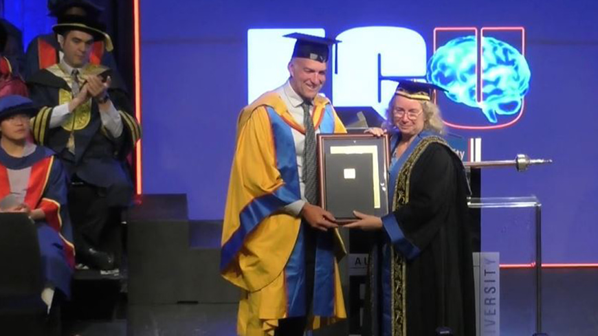 Tim Jarvis in gown on left being presented with honorary doctorate by ECU Chancellor