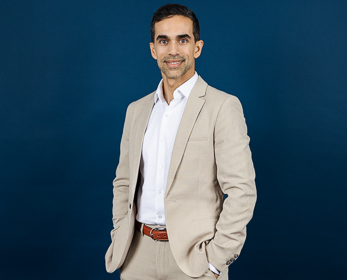 Dr Ali Nazari Tehrani in front of a navy blue background