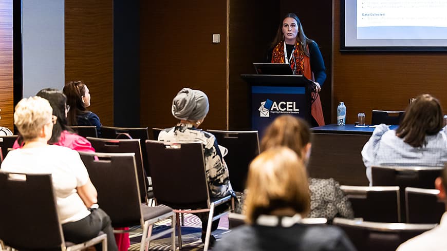 Woman presenting at a conference.