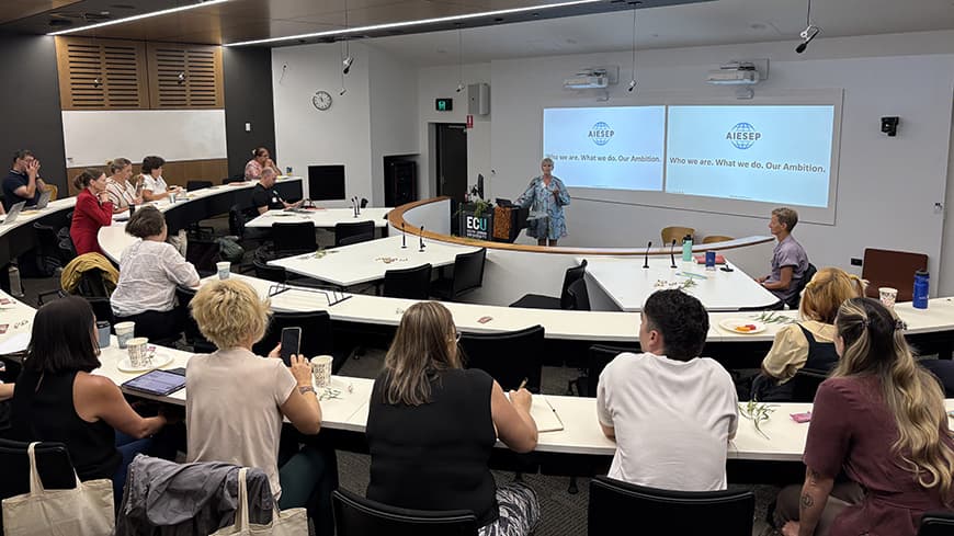 People sitting in lecture theatre.