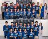 A group of people wearing graduation regalia.