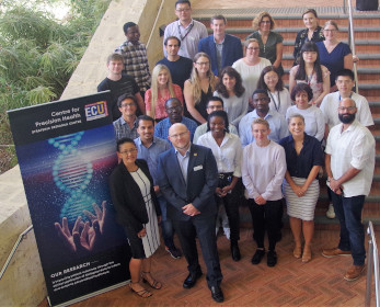 Centre members including postgraduate students posing on steps of building 21 ECU