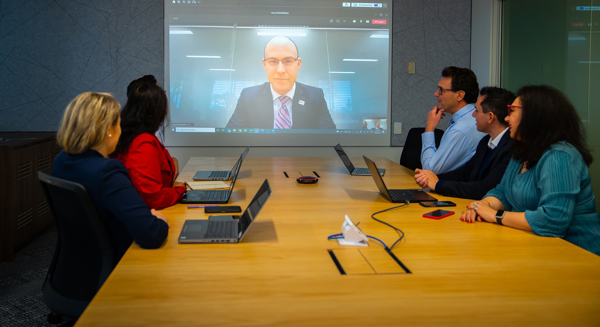 Centre for Work and Wellbeing on a video call in a conference room.