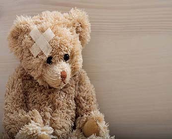 teddy bear with a Band-Aid on its ear
