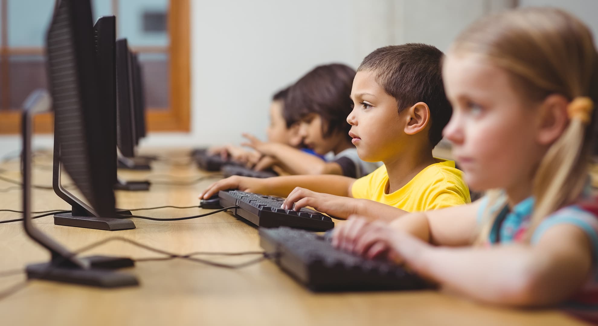 Children sitting at computers at their desk