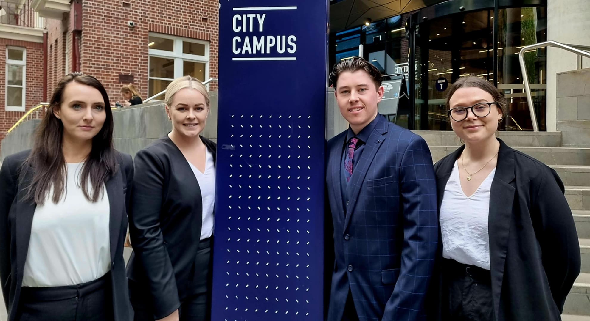 Jenna Long, Sara-Jane Dempsey, Jacob Orley and Olivia Caubo standing outside Victoria University.