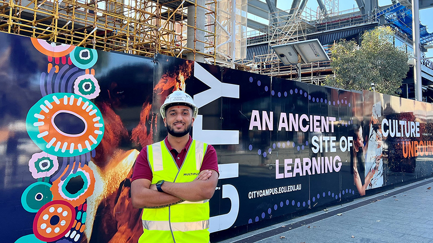 Munish Senghani wear a safety vest and helmet at the ECU City construction site.