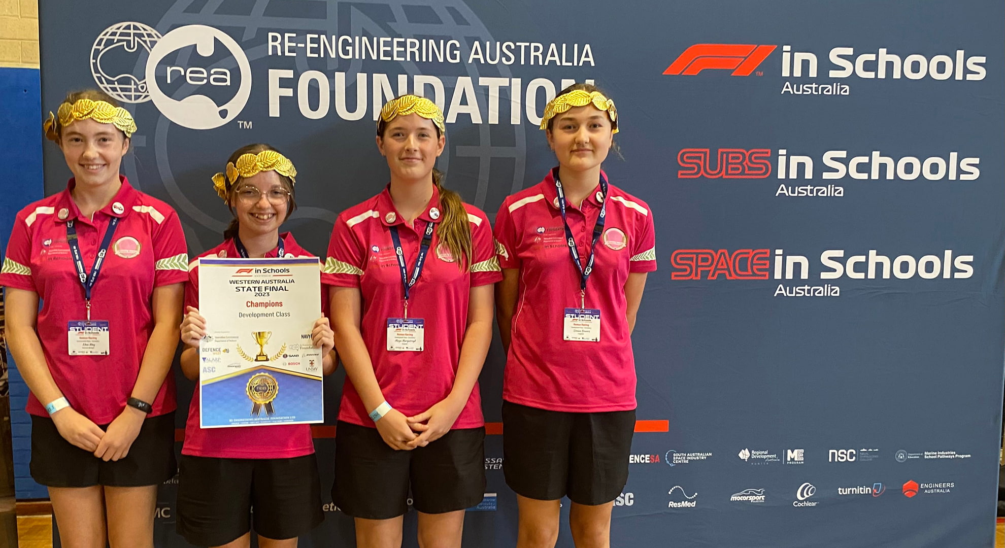 Remus Racing members Eden, Hannah, Maya and Sienna stand together with their Champions award.