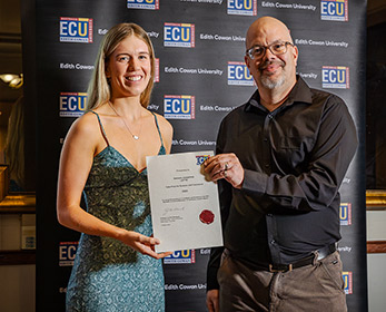 A photo of Samar Lette receiving the Talis prize, presented by Andrew Mack.