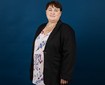 Associate Professor Shannon Bosch in front of a navy blue background