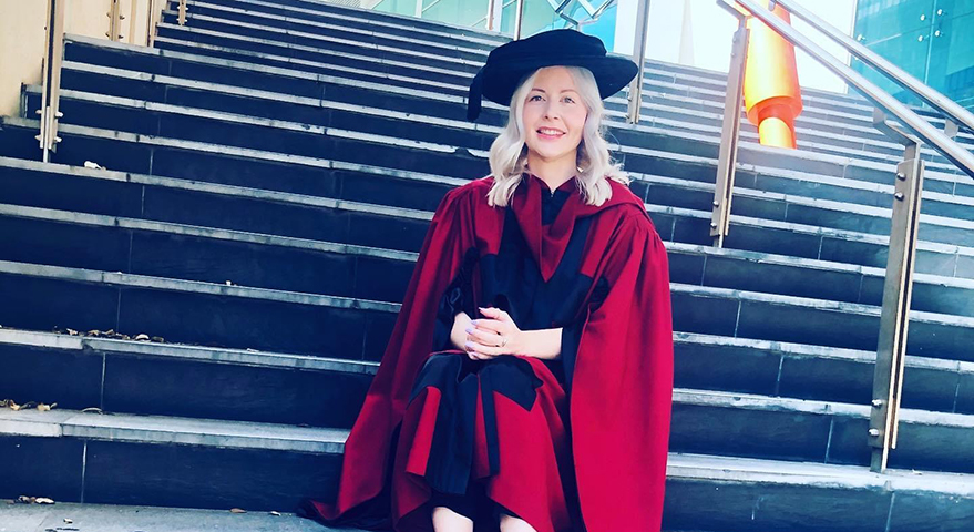 Woman dressed in university graduation attire