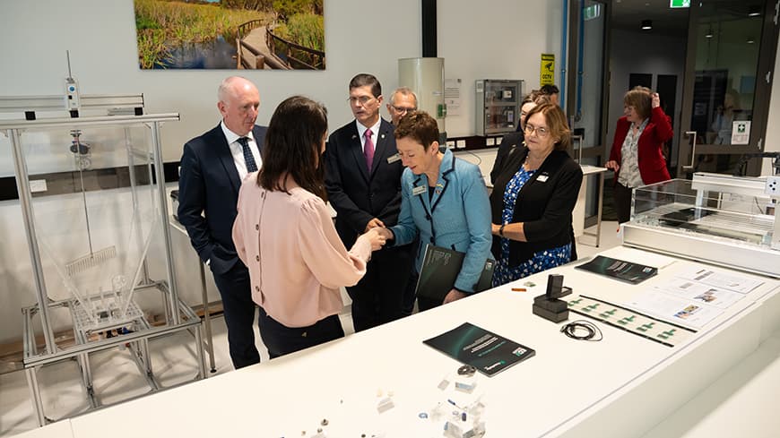 A group of people looking at ceramic examples.