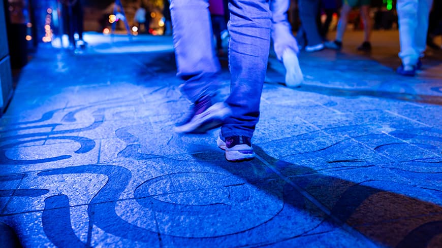 Blue light reflecting off an etched carving.