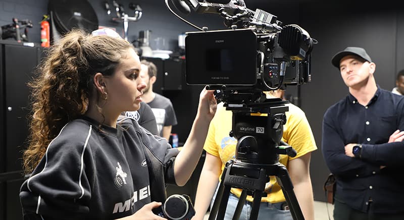 A student with a TV camera