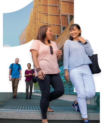 Two women walking past ECU Joondalup Ngoolark building