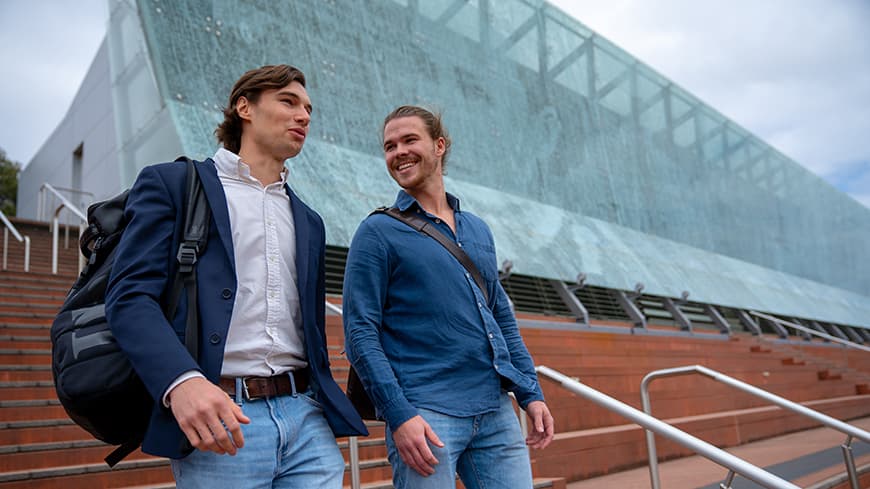 Two male university students in conversation.