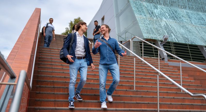 Students walking down the steps of Edith Cowan University's School of Business and Law building.