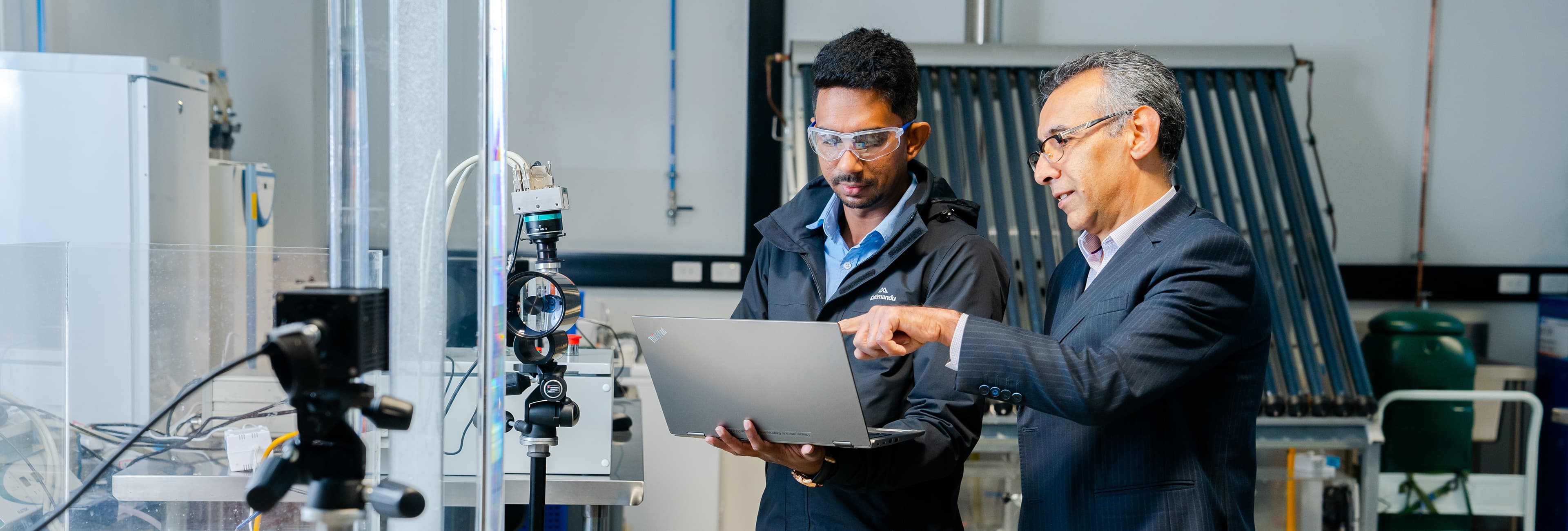 Two men looking at laptop