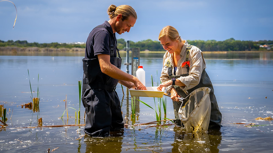 Man and woman working in a river