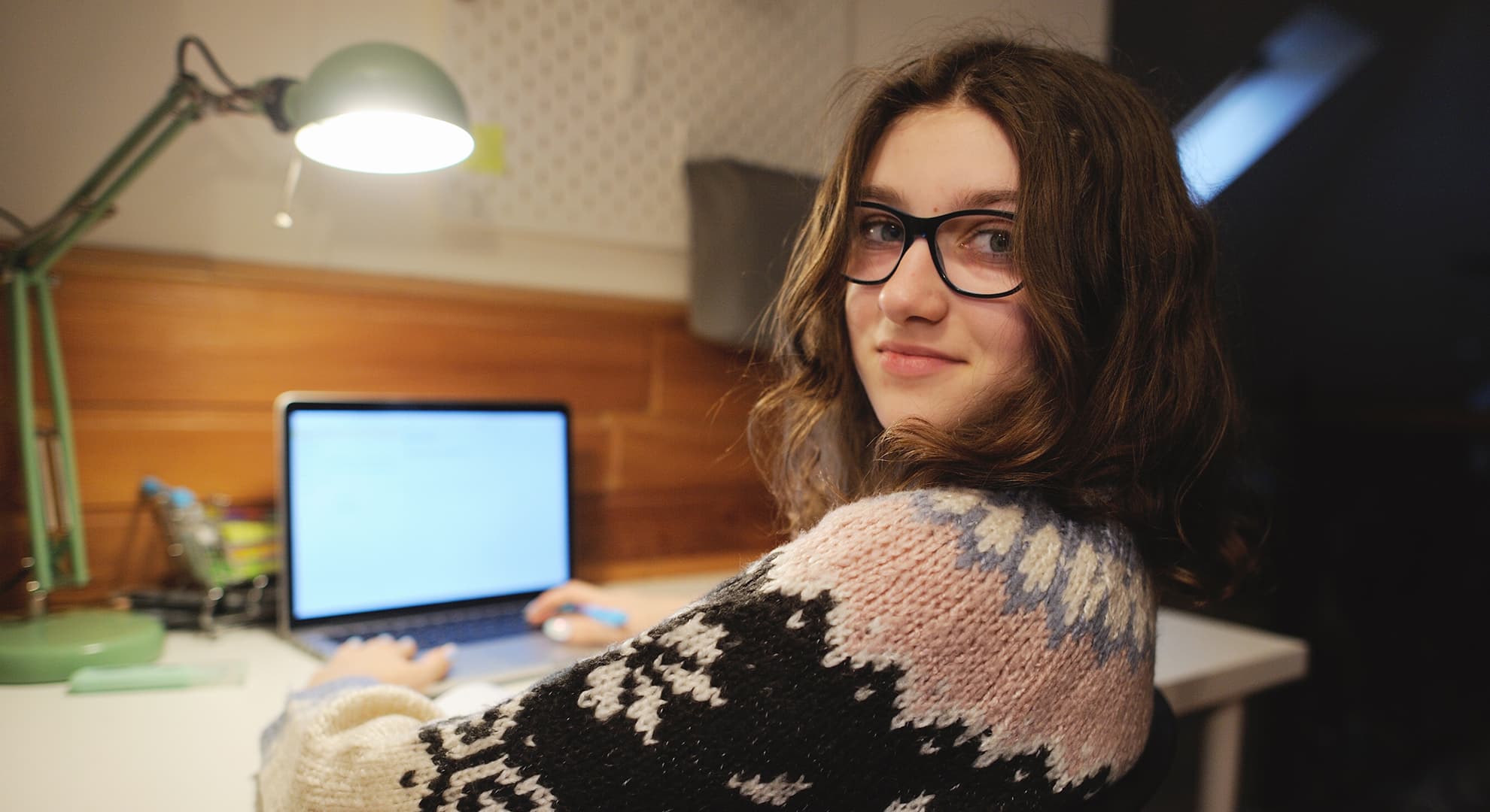 Young woman sitting at a desk with a computer