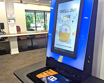 A close-up short of a new self-checkout kiosk at Mount Lawley Campus Library. The display is dynamic and colourful.