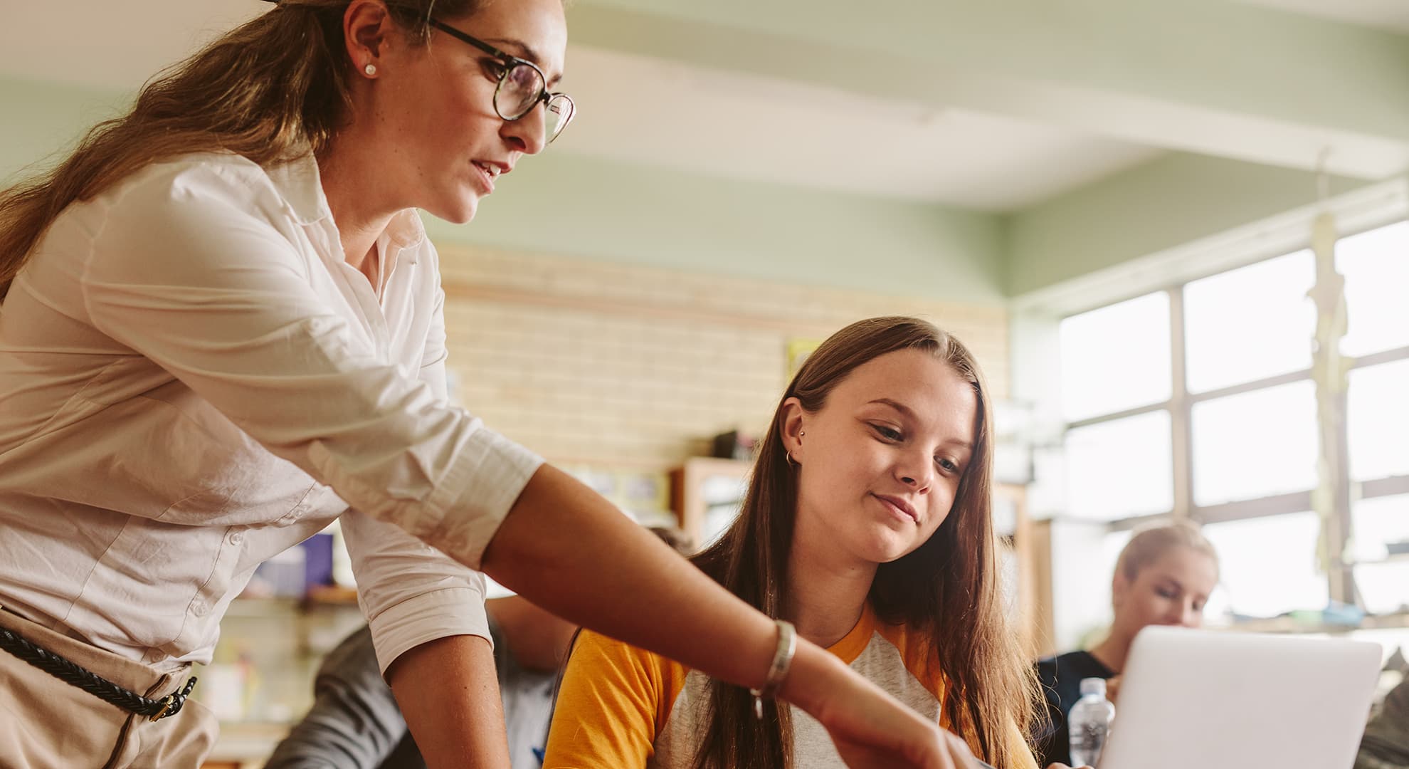 Student at computer with teacher