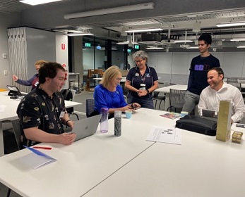 Elliot Rosignoli, Michelle Ellis, examining location data with Rachael Lehr and David Donnelly. 