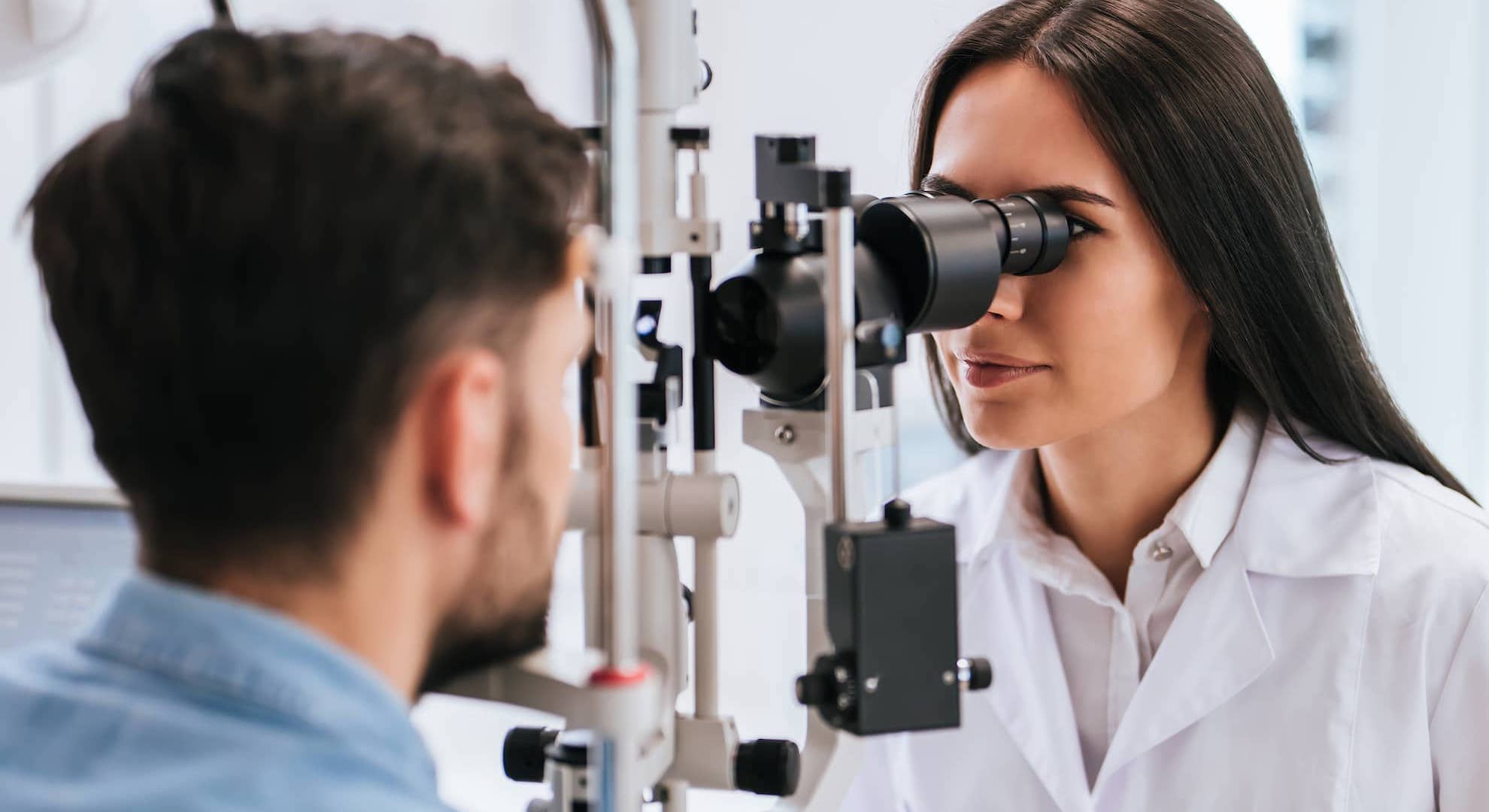 Doctor conducting an eye test on a male patient