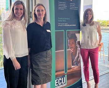 Three ECU School of Science staff standing next to an ECU banner. 