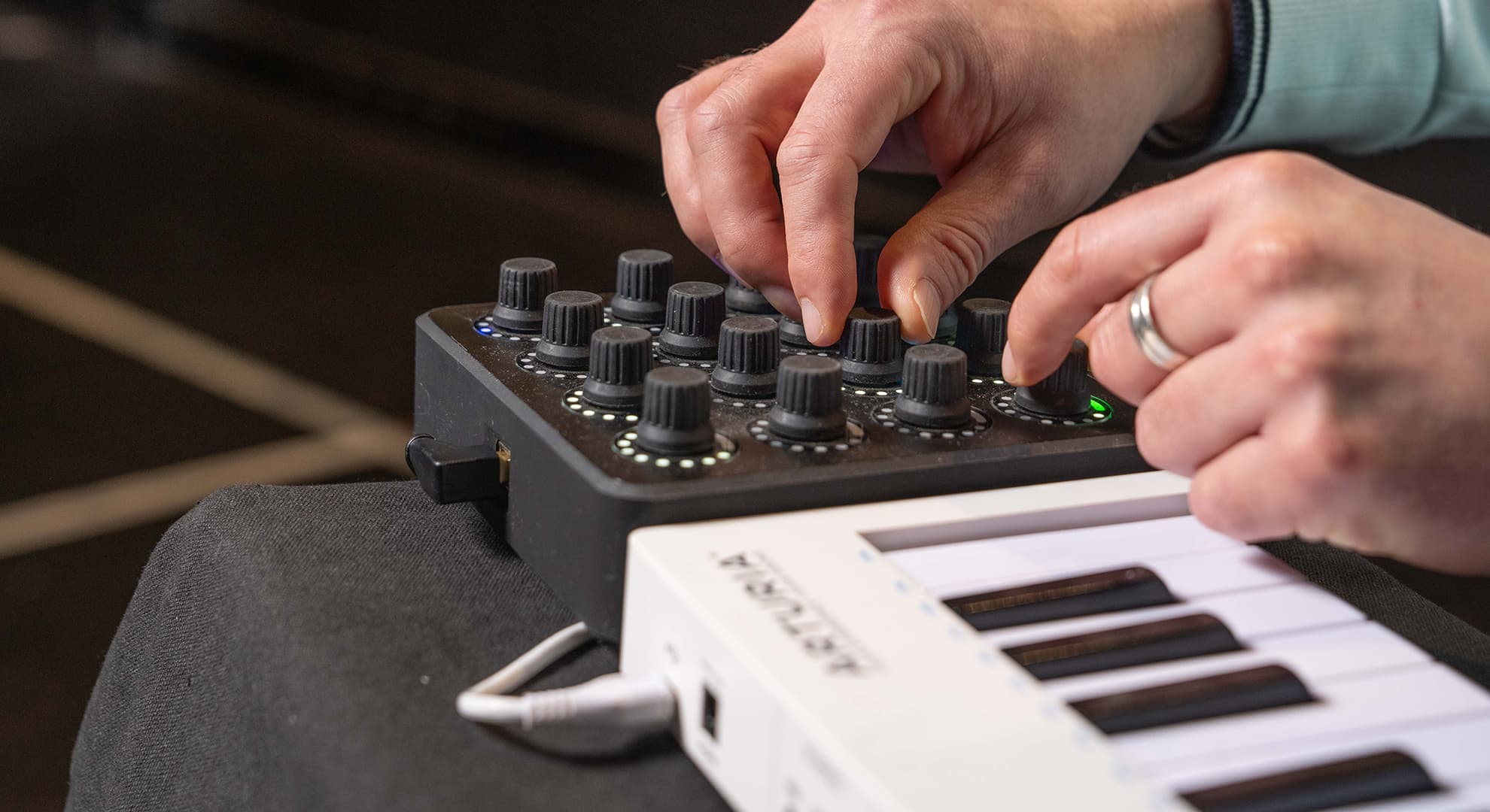 man adjusting keyboard dials